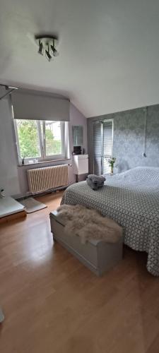 a bedroom with a large bed and a large window at Bed vue sur vallée de la Meuse Namur in Bouge