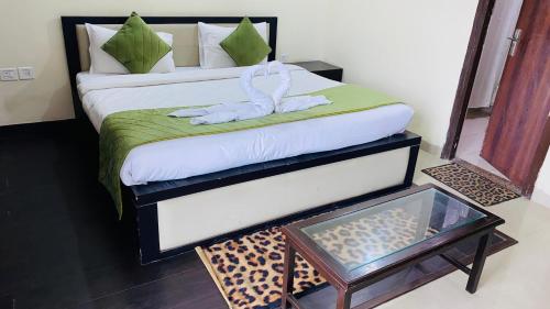 a hotel room with a bed with a towel on it at LivBox in Rāmpura