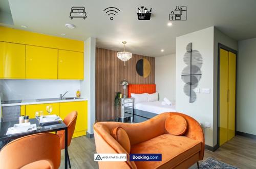 a kitchen and a living room with a couch and a bed at Exquisite Central Suites Sheffield in Sheffield