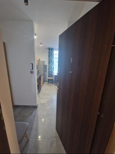 a hallway with a wooden wall in a room at Apartament Zacisze 5 in Przemyśl