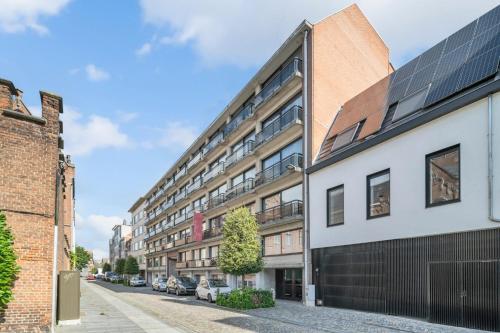 an apartment building on a street with parked cars at Value Stay Residence Mechelen in Mechelen