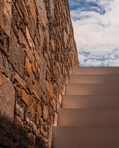 a staircase leading up to a brick wall at CAMPO SUITES in Kampos Paros