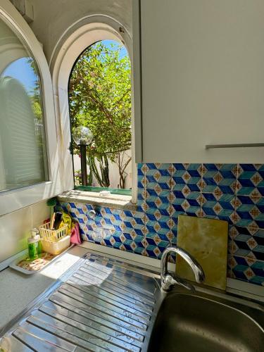a kitchen with a sink and a window at La Casa di Bubi in Anacapri