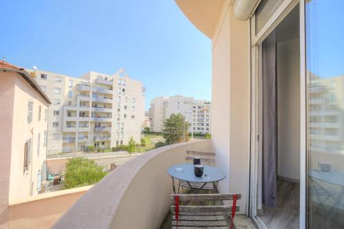 une table sur un balcon avec vue sur une ville dans l'établissement Cosy et Calme proche métro Montplaisir, à Lyon