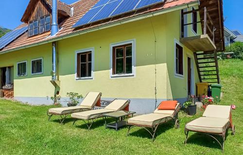 a group of chairs and a house with solar panels at Großes Ferienhaus In Oberwoelz in Oberwölz Stadt