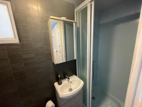 a bathroom with a sink and a toilet and a mirror at Les Allées Provençales in Montélimar