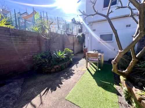 a small garden with a table and a building at Rear Garden Suite in Sydney