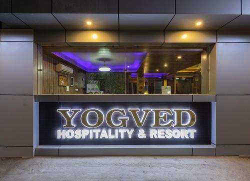 a sign in the window of a hospitalhospitality and resort at Yogved Hospitality & Resort in Rishīkesh