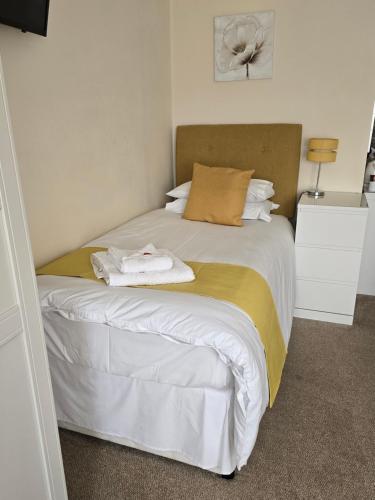 a bedroom with a bed with two towels on it at Chilton Villa B&B in Sandwich