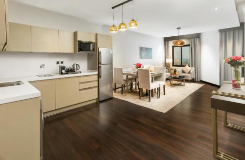 an open kitchen and living room in a apartment at The Address Serviced Apartments in Al Khobar