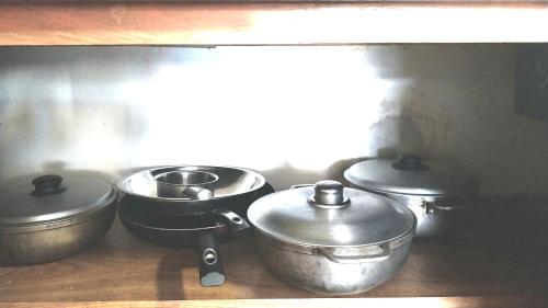 a group of pots and pans in a kitchen at The biggest swimming pool in Sosua, frente a la piscina más grande en sosua in Sosúa