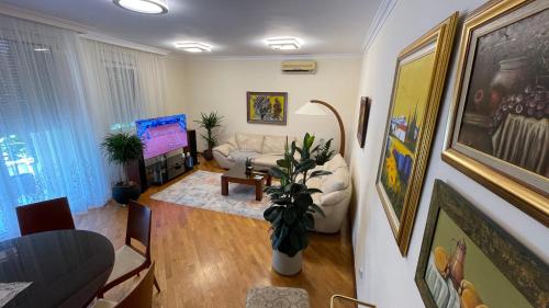 a living room with a couch and a chair at Top secret 24 in Belgrade