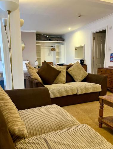 a living room with two couches and a couch at Tyacks Hotel in Camborne