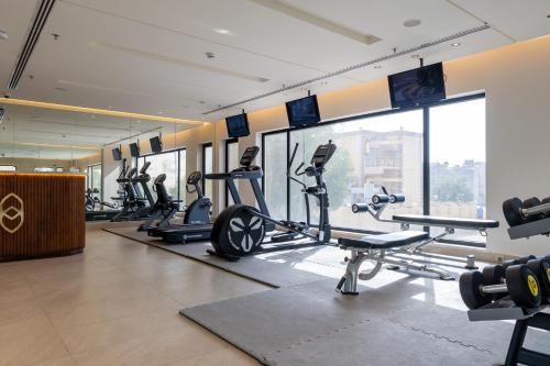 a gym with treadmills and cardio equipment in a building at The Address Serviced Apartments in Al Khobar