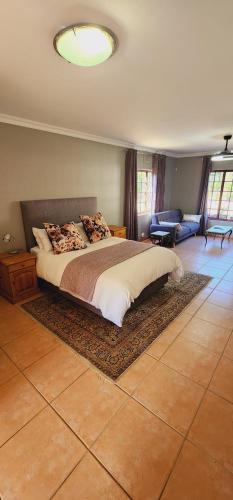 a bedroom with a bed and a living room at Gorgeous Garden Villa in Gillitts-Emberton