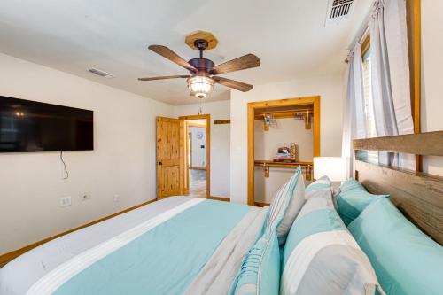 a bedroom with a bed and a ceiling fan at Quitman Lakefront Cabin with Screened Porch and Grill! in Quitman