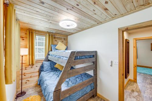 a bunk bed in a tiny house at Quitman Lakefront Cabin with Screened Porch and Grill! in Quitman