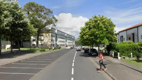 a person riding a skateboard down a street at Ponta Delgada 3 Bedroom Apartment in Ponta Delgada