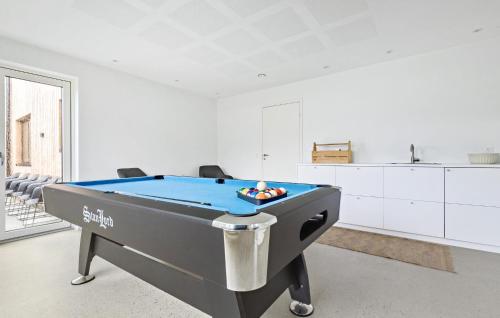 a pool table in a white room with a pool at 5 Bedroom Awesome Home In Ebeltoft in Ebeltoft