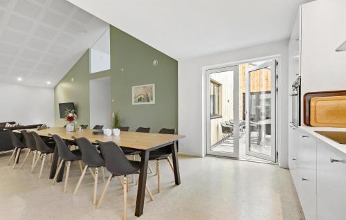 a dining room with a table and chairs at 5 Bedroom Awesome Home In Ebeltoft in Ebeltoft