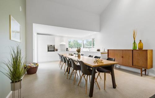 a kitchen and dining room with a table and chairs at 5 Bedroom Awesome Home In Ebeltoft in Ebeltoft