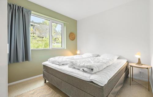 a bed in a bedroom with a window at 5 Bedroom Awesome Home In Ebeltoft in Ebeltoft