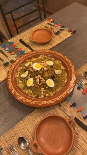 a bowl of food with eggs on a table at Maison ALPHEA SPA HAMMAM in Marrakech