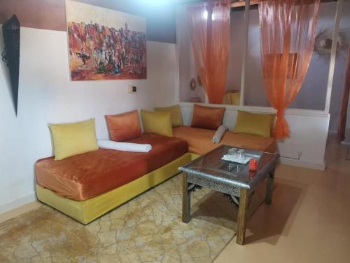 a living room with a couch and a table at Maison ALPHEA SPA HAMMAM in Marrakech
