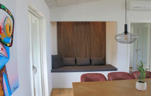 a room with a bench with a table and chairs at Beautiful Home In Børkop With Kitchen in Børkop
