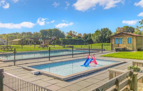 a swimming pool with two slides in a playground at Awesome Stacaravan In Tzummarum in Tzummarum