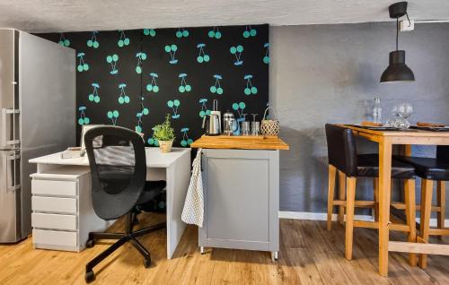 a room with a desk and a table with chairs at Awesome Apartment In Göteborg With Wifi in Gothenburg
