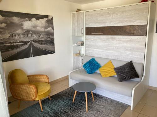 a living room with a couch and a chair at La Maloyette in La Possession