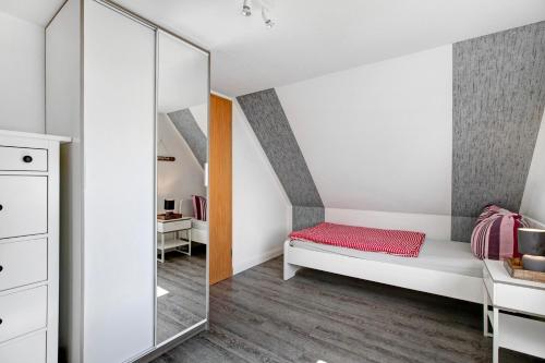a bedroom with a bed and a mirror at Ferienhaus Schleiluft in Kappeln