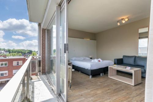 a hotel room with a bed and a couch at Value Stay Residence Mechelen in Mechelen