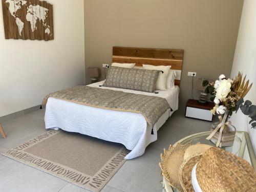 a bedroom with a large bed and a glass table at La bastide de marie in Robion en Luberon