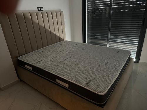 a bed sitting in a room with a mattress at Copacabana in Kenitra