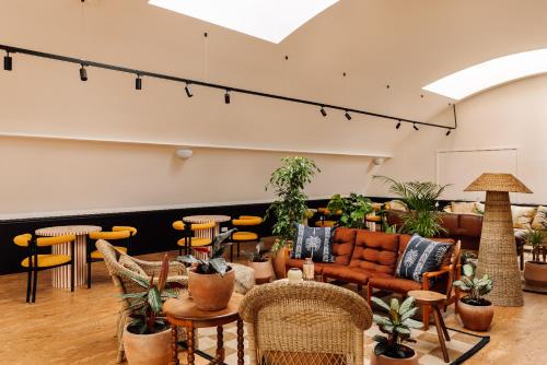 a living room with a couch and tables and chairs at Locke de Santa Joana in Lisbon