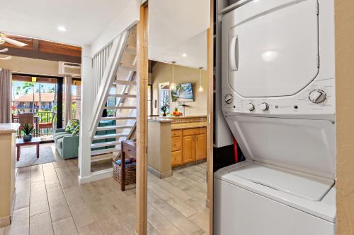 a kitchen and a living room with a refrigerator at Papakea E404 in Kahana