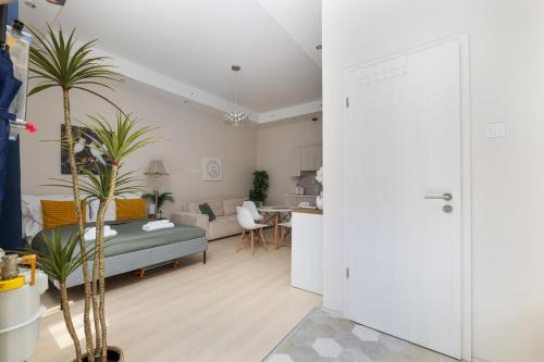 a living room with a bed and a kitchen at Pure Heaven Apartment in Budapest