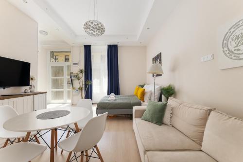 a living room with a couch and a table at Pure Heaven Apartment in Budapest