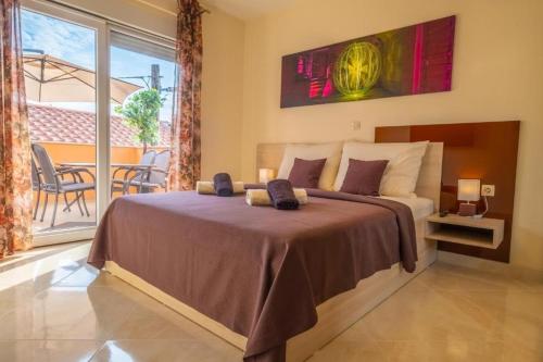 a bedroom with a large bed and a balcony at La Dama in Novi Vinodolski