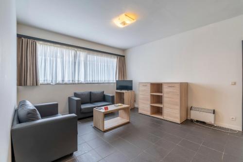 a living room with a couch and a table at Value Stay Residence Mechelen in Mechelen