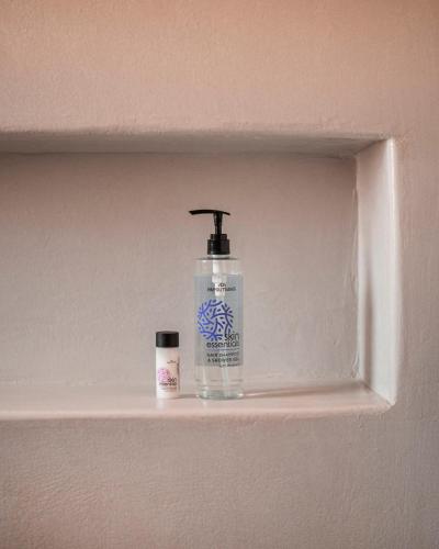 a bottle of mouthwash sitting on a shelf in a bathroom at CAMPO SUITES in Kampos Paros