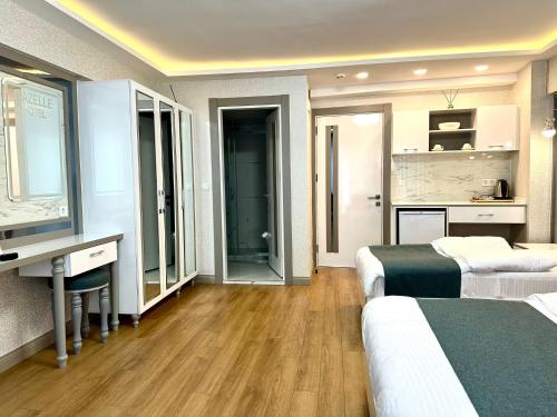 a hotel room with two beds and a desk at gazelle suites in Istanbul