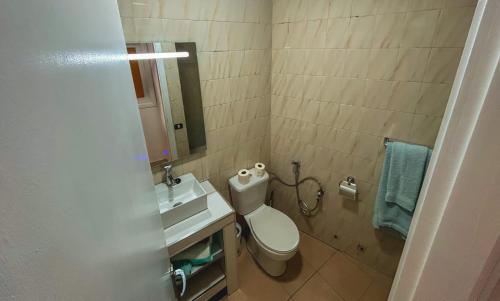 a bathroom with a toilet and a sink and a mirror at La promesa in Arona