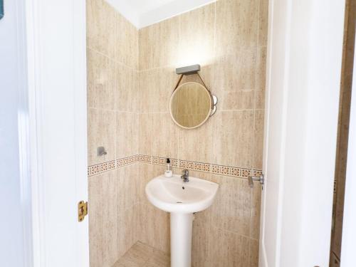 a bathroom with a sink and a mirror at Ocean Front Teneriffa 2 Bedroom Penthouse Costa Adeje in Callao Salvaje