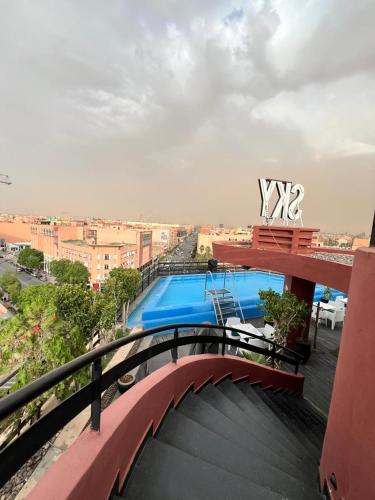a bridge over a swimming pool on top of a building at La Renaissance hôtel Marrakech in Marrakech