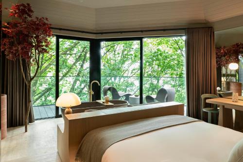 a bedroom with a bed and a large window at The Montenotte Hotel in Cork