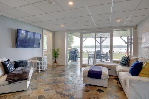 a living room with couches and a flat screen tv at La vie O-Lac Magog in Sherbrooke