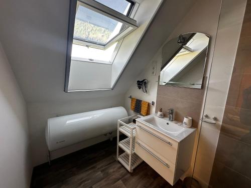 a bathroom with a sink and a skylight at See Panzió in Fertőrákos